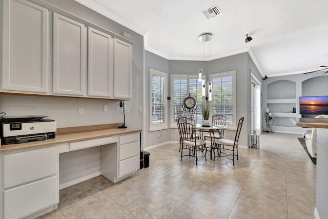 dining area with visible vents, built in study area, baseboards, ornamental molding, and light tile patterned flooring