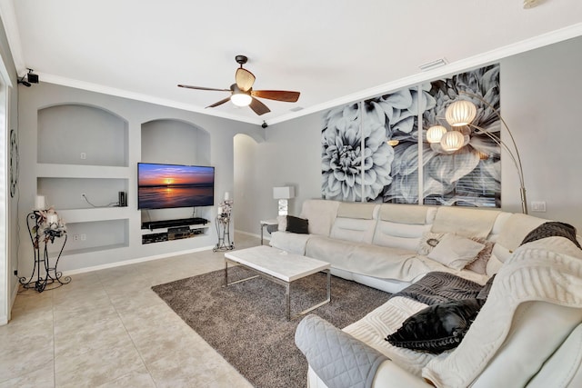 living area featuring crown molding, visible vents, built in features, ceiling fan, and tile patterned floors