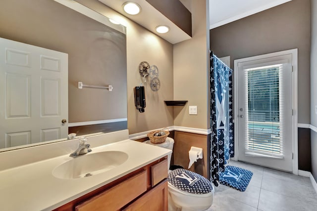 bathroom featuring a shower with shower curtain, a healthy amount of sunlight, tile patterned flooring, and vanity