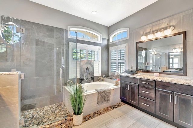 bathroom with a garden tub, vanity, and a shower stall