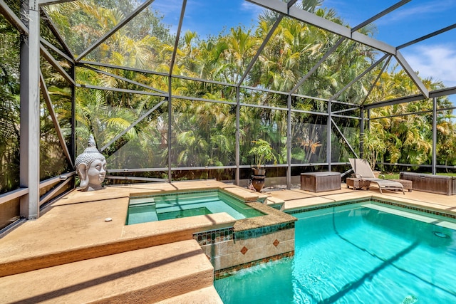 view of pool with a patio area, a lanai, and a pool with connected hot tub