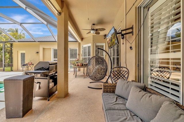 view of patio with grilling area, ceiling fan, an outdoor living space, and a lanai