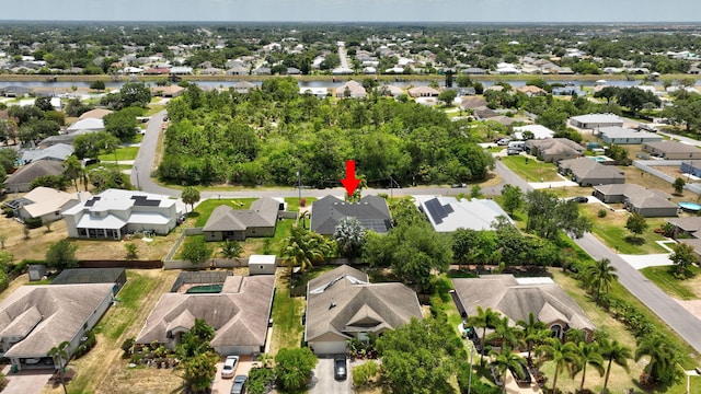 drone / aerial view featuring a residential view and a water view