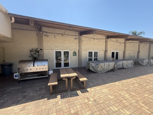 view of patio / terrace featuring french doors, outdoor dining area, and grilling area