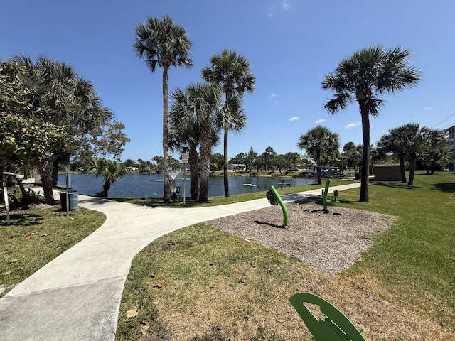 view of property's community featuring a water view and a yard