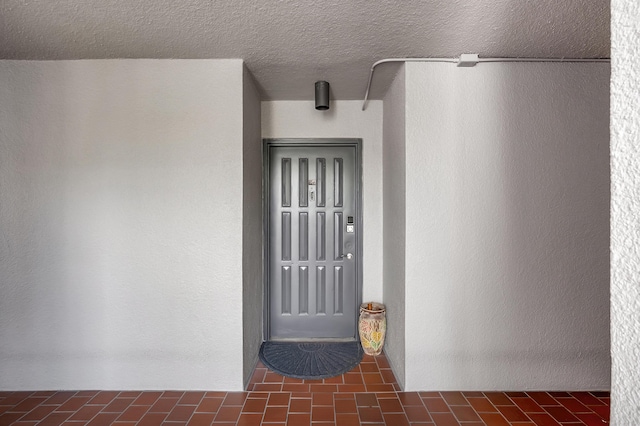 view of exterior entry featuring stucco siding