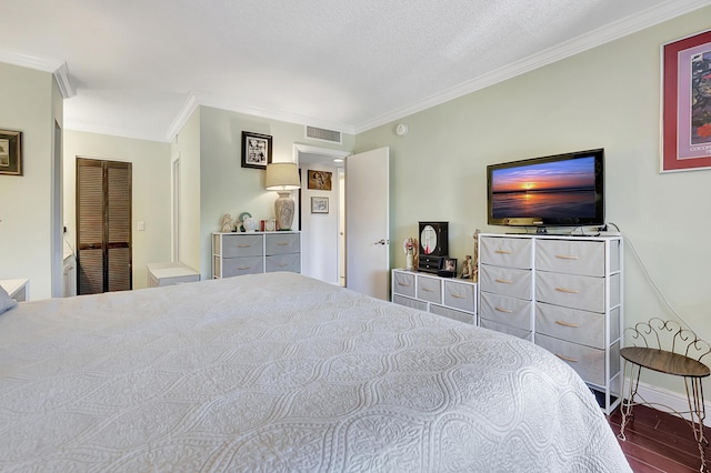 bedroom featuring baseboards, visible vents, ornamental molding, and wood finished floors