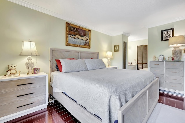 bedroom featuring crown molding and dark wood finished floors