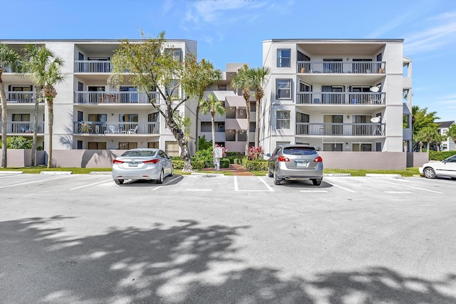 view of building exterior featuring uncovered parking