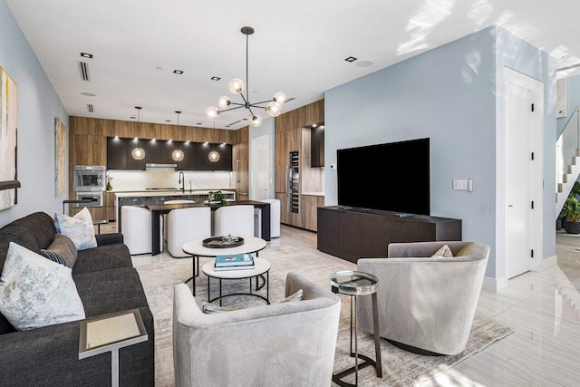 914 Palm Trl, Delray Beach, FL 33483 - living room featuring marble finish floor, stairs, and a notable chandelier