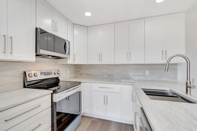 2003 20th Way, West Palm Beach, FL 33407 - kitchen with stainless steel appliances, a sink, white cabinets, recessed lighting, and light stone countertops