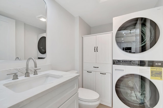 2003 20th Way, West Palm Beach, FL 33407 - bathroom with stacked washing machine and dryer, toilet, and vanity