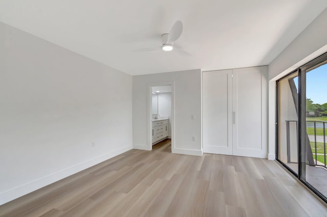 2003 20th Way, West Palm Beach, FL 33407 - unfurnished bedroom with light wood finished floors, access to exterior, baseboards, ensuite bath, and a ceiling fan