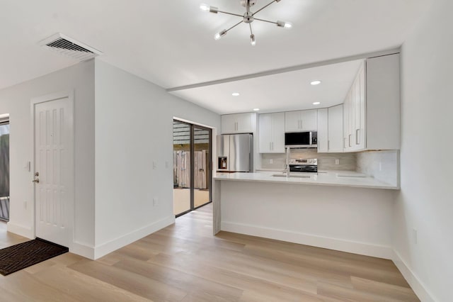 2003 20th Way, West Palm Beach, FL 33407 - kitchen with appliances with stainless steel finishes, light wood-type flooring, backsplash, baseboards, and recessed lighting