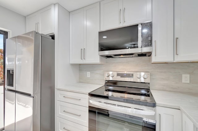2003 20th Way, West Palm Beach, FL 33407 - kitchen with stainless steel appliances, white cabinets, backsplash, and light stone counters