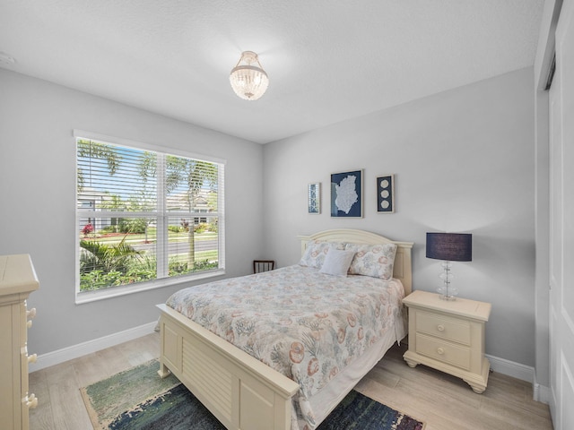 12495 SW Sunrise Lake Ter, Port Saint Lucie, FL 34987 - bedroom featuring light wood-style flooring and baseboards