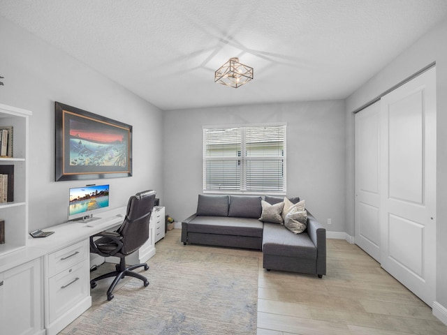 12495 SW Sunrise Lake Ter, Port Saint Lucie, FL 34987 - home office with a textured ceiling and light wood-style floors