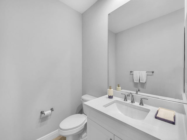 12495 SW Sunrise Lake Ter, Port Saint Lucie, FL 34987 - bathroom with toilet, vanity, and baseboards