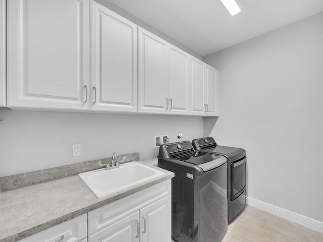 12495 SW Sunrise Lake Ter, Port Saint Lucie, FL 34987 - washroom featuring independent washer and dryer, cabinet space, baseboards, and light wood-style flooring