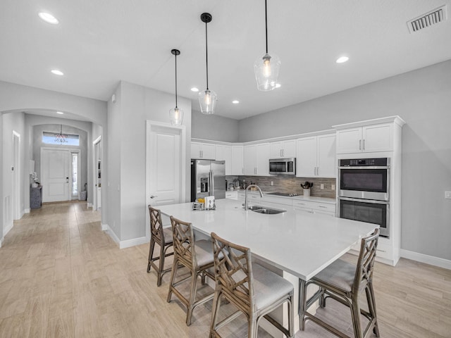 12495 SW Sunrise Lake Ter, Port Saint Lucie, FL 34987 - kitchen with appliances with stainless steel finishes, arched walkways, a sink, baseboards, and recessed lighting