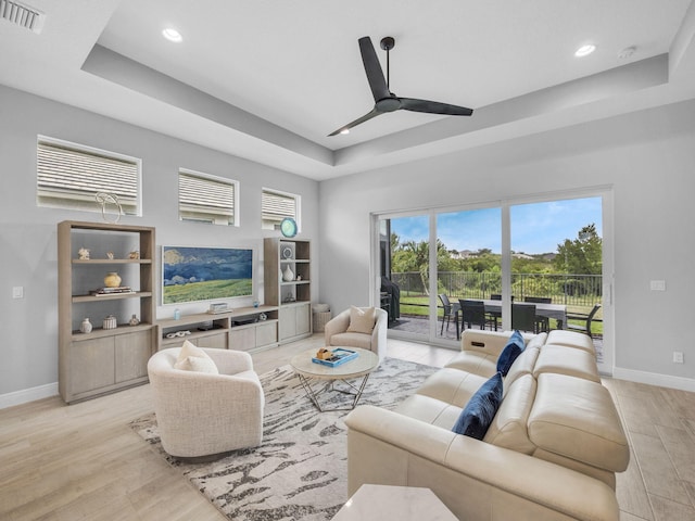 12495 SW Sunrise Lake Ter, Port Saint Lucie, FL 34987 - living room with baseboards, light wood finished floors, a raised ceiling, recessed lighting, and ceiling fan