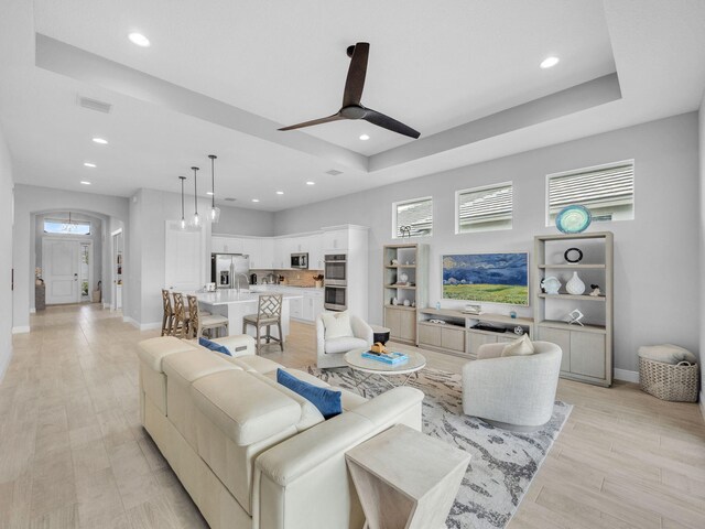12495 SW Sunrise Lake Ter, Port Saint Lucie, FL 34987 - living room featuring a ceiling fan, recessed lighting, baseboards, and light wood finished floors