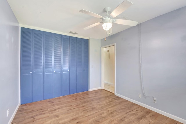 2811 Ashley Dr E Unit E, West Palm Beach, FL 33415 - unfurnished bedroom featuring a ceiling fan, baseboards, wood finished floors, and a closet