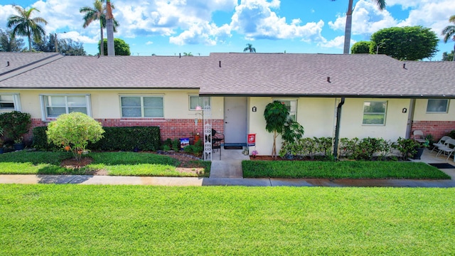 2811 Ashley Dr E Unit E, West Palm Beach, FL 33415 - single story home featuring a shingled roof, stucco siding, a front lawn, and brick siding