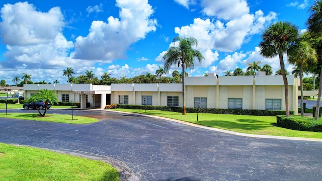 2811 Ashley Dr E Unit E, West Palm Beach, FL 33415 - view of front of house with uncovered parking, a front yard, and stucco siding