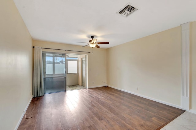 2811 Ashley Dr E Unit E, West Palm Beach, FL 33415 - spare room featuring baseboards, ceiling fan, wood finished floors, and visible vents