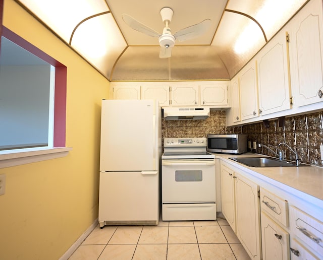205 Mansfield E, Boca Raton, FL 33434 - kitchen with white appliances, under cabinet range hood, tasteful backsplash, a sink, and light tile patterned floors