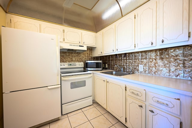 205 Mansfield E, Boca Raton, FL 33434 - kitchen featuring backsplash, a sink, light tile patterned floors, under cabinet range hood, and white appliances