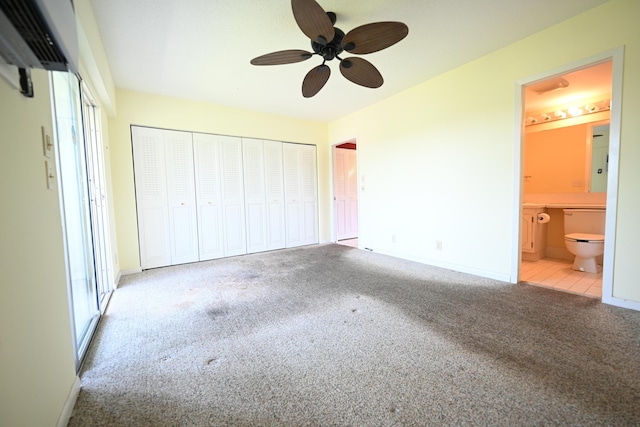 205 Mansfield E, Boca Raton, FL 33434 - unfurnished bedroom featuring connected bathroom, baseboards, ceiling fan, and carpet
