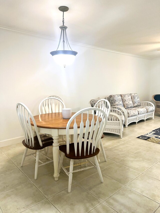 tiled dining room with ornamental molding