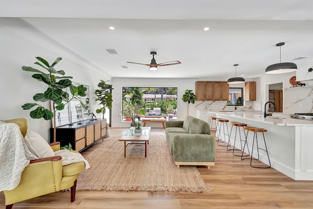 living room with recessed lighting, ceiling fan, visible vents, and light wood-style flooring