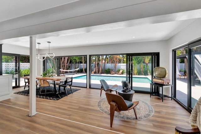 dining area featuring an inviting chandelier, recessed lighting, and wood finished floors