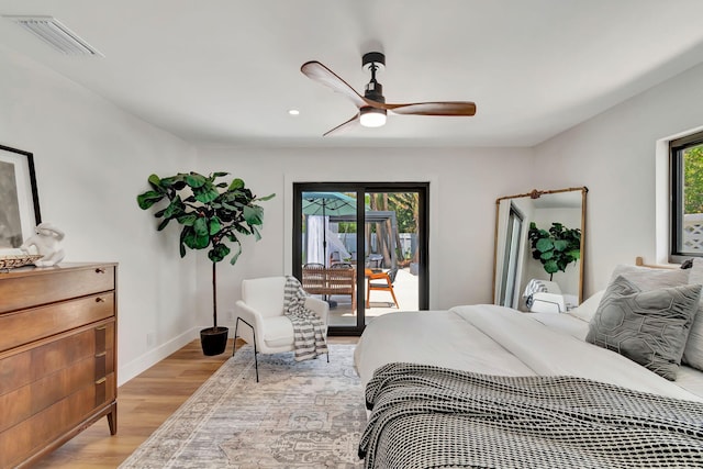 bedroom featuring access to outside, visible vents, multiple windows, and light wood-style floors