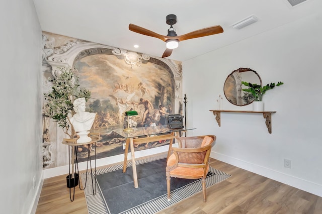 home office featuring baseboards, ceiling fan, wood finished floors, and visible vents