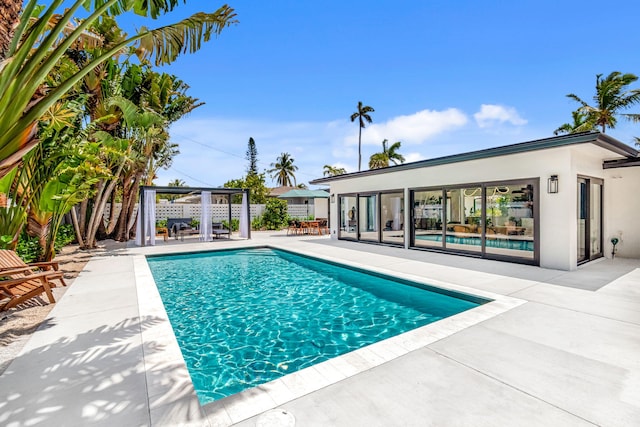 view of swimming pool featuring a gazebo, a patio area, fence, and a fenced in pool
