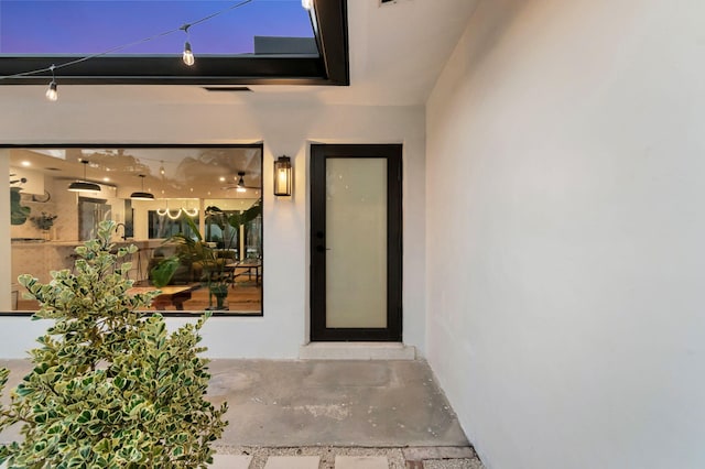 doorway to property with stucco siding