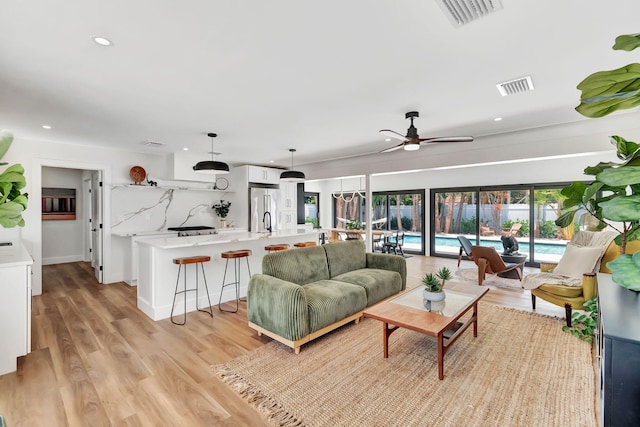 living area featuring ceiling fan, recessed lighting, and visible vents