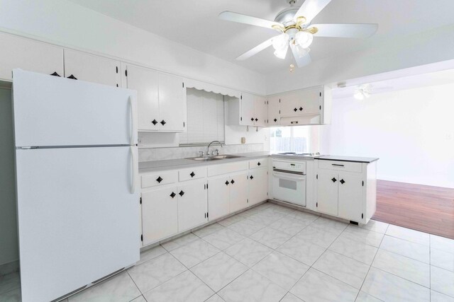 2607 Wiley St, Hollywood, FL 33020 - kitchen with white cabinets, ceiling fan, a sink, white appliances, and light countertops