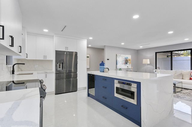 200 SW 12th St, Boca Raton, FL 33432 - kitchen featuring white cabinets, a sink, stainless steel appliances, recessed lighting, and modern cabinets