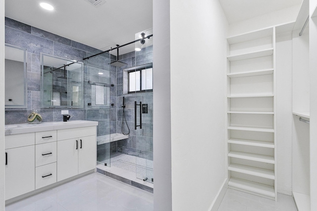 200 SW 12th St, Boca Raton, FL 33432 - full bathroom with visible vents, a shower stall, a walk in closet, and vanity