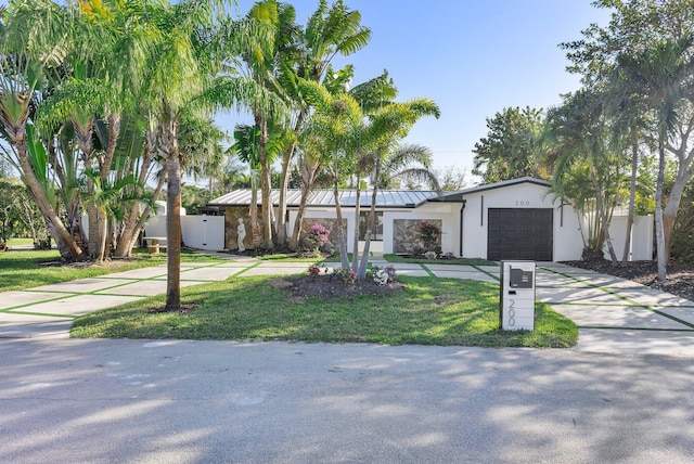 200 SW 12th St, Boca Raton, FL 33432 - view of front of house featuring driveway, fence, a front lawn, an attached garage, and stucco siding