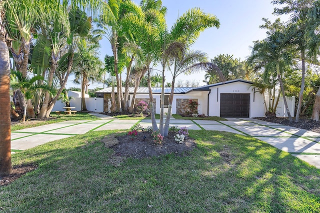 200 SW 12th St, Boca Raton, FL 33432 - view of front of house featuring driveway, a garage, fence, a front lawn, and stucco siding