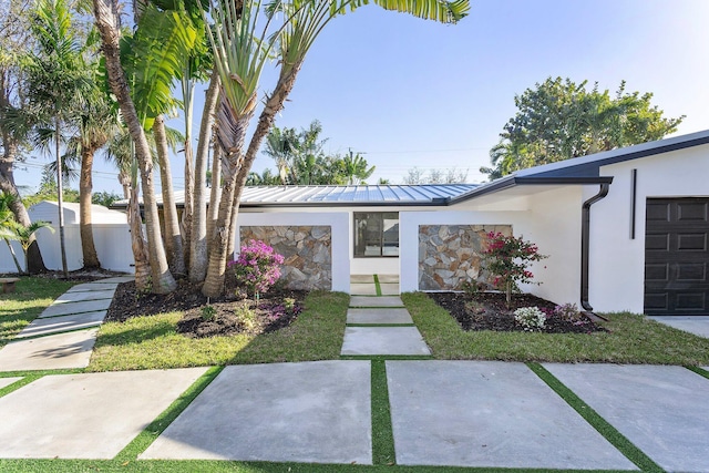 200 SW 12th St, Boca Raton, FL 33432 - view of front of home featuring a standing seam roof, stucco siding, metal roof, and stone siding