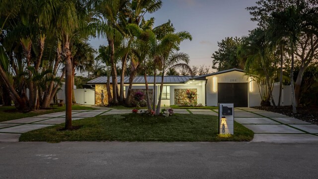 200 SW 12th St, Boca Raton, FL 33432 - view of front of house with a standing seam roof, an attached garage, concrete driveway, and a front yard
