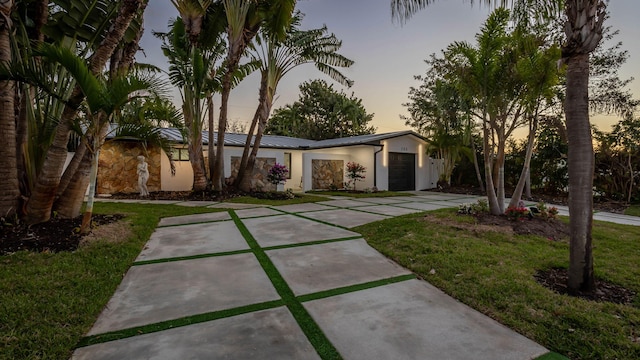 200 SW 12th St, Boca Raton, FL 33432 - mid-century home with an attached garage, stucco siding, a yard, and driveway