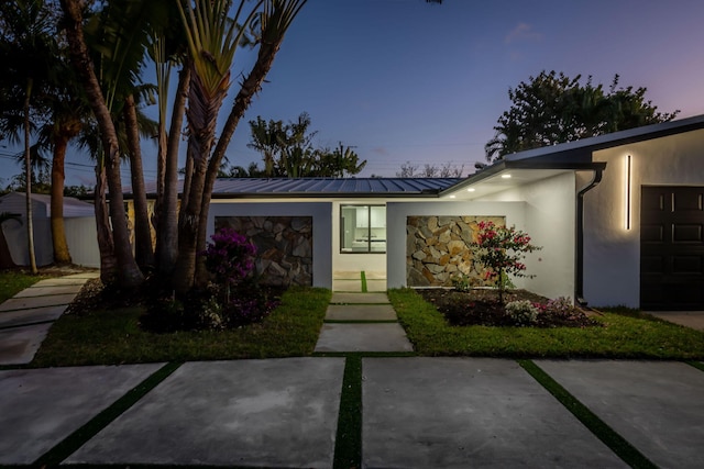 200 SW 12th St, Boca Raton, FL 33432 - view of front of home featuring a garage, a standing seam roof, metal roof, and stucco siding